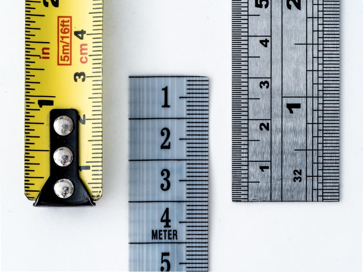 Rulers fanned across a pale backdrop